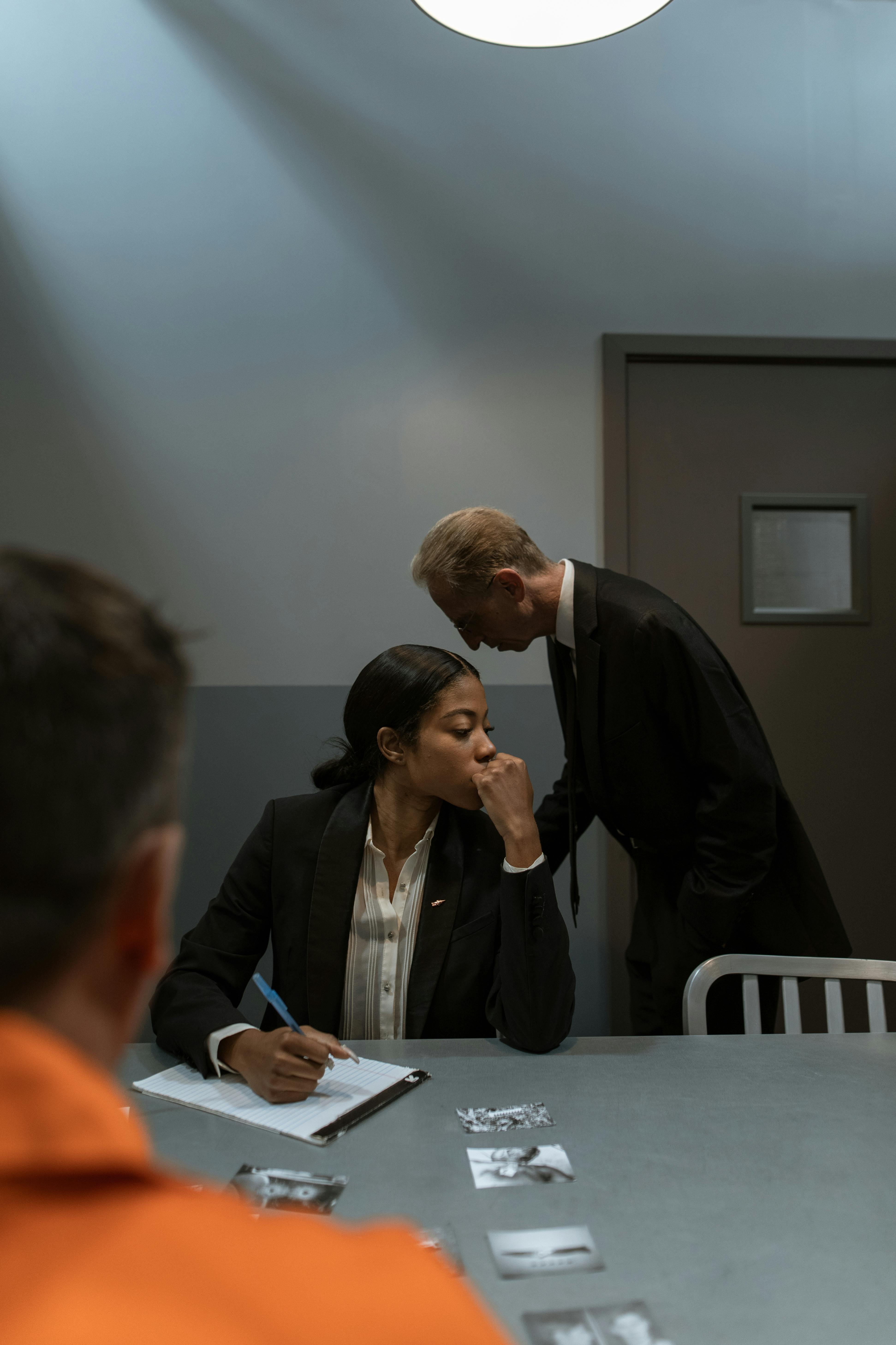 A determined criminal defense lawyer standing with their client, ready to ensure a fair trial.