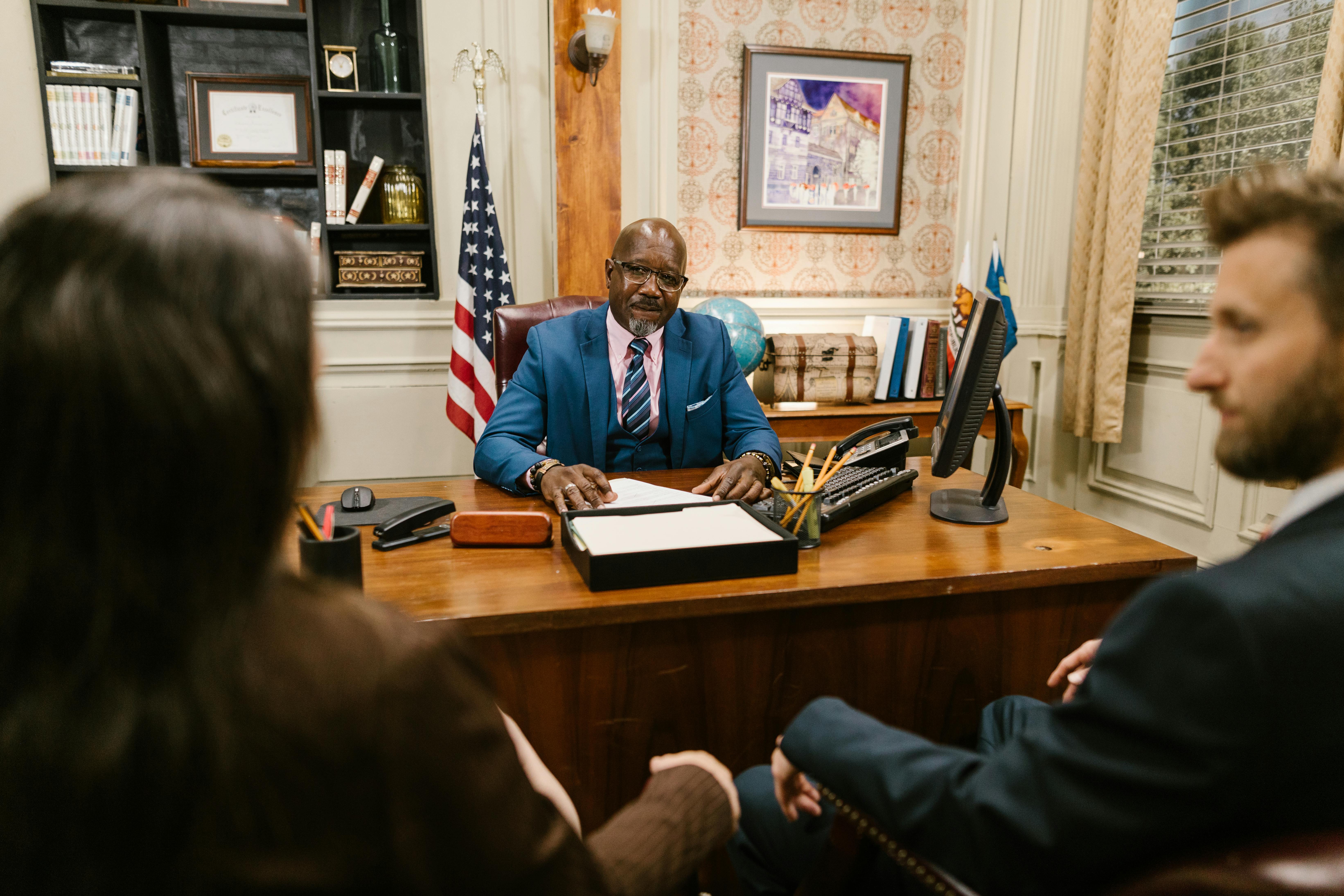 A caring family law attorney offering guidance to a client in a calm, supportive office.